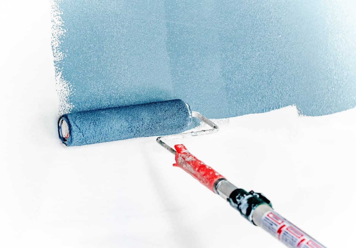 Professional painter rolling a wall